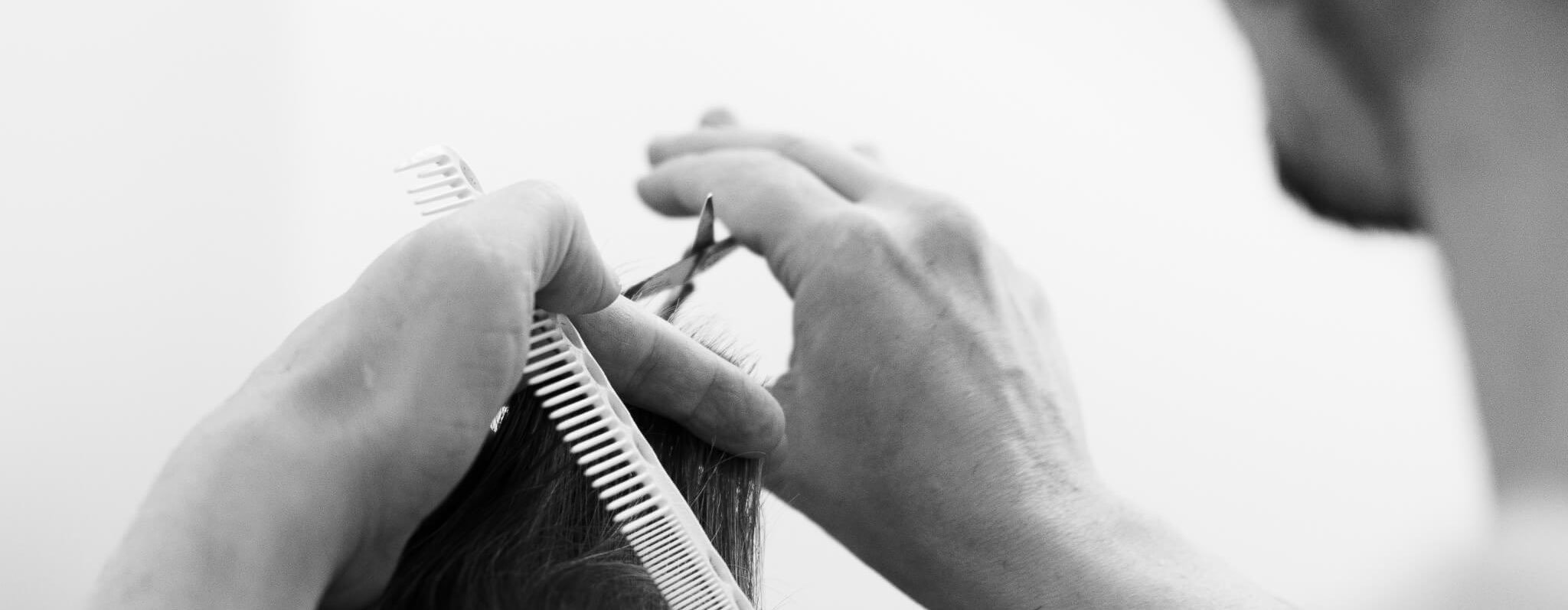 Hair being cut with scissor and comb