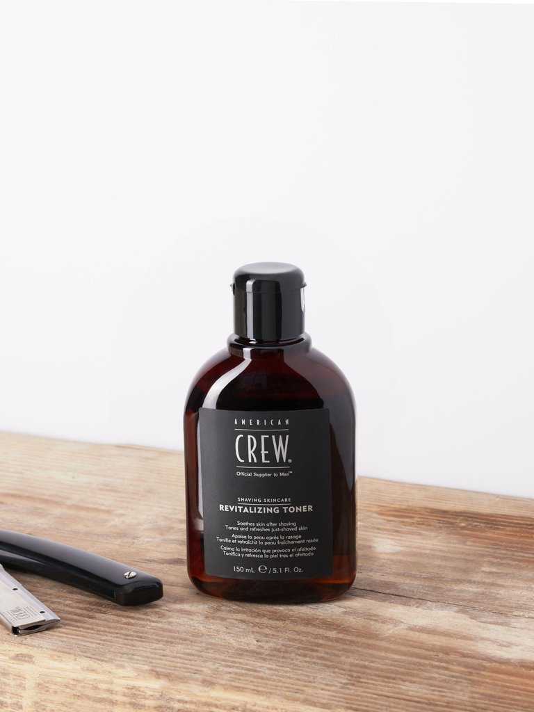 American Crew Revitalizing Aftershave on table with shavette